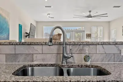 a kitchen counter with a sink in a kitchen at Shells and Bells Ocean Paradise - Sleeps 24, 2 Private Pools in Panama City Beach
