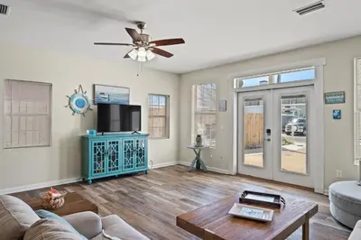 a living room with a couch and a ceiling fan at Shells and Bells Ocean Paradise - Sleeps 24, 2 Private Pools in Panama City Beach