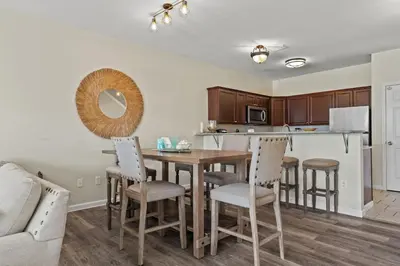 a kitchen and dining room with a table and chairs at Shells and Bells Ocean Paradise - Sleeps 24, 2 Private Pools in Panama City Beach
