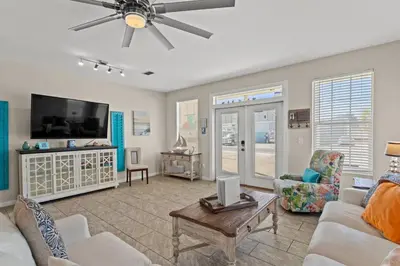 a living room with a couch and a flat screen tv at Shells and Bells Ocean Paradise - Sleeps 24, 2 Private Pools in Panama City Beach