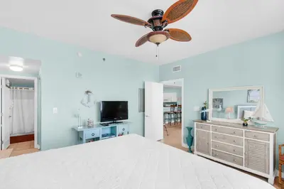 a bedroom with a bed and a ceiling fan at Shores of Panama 1617 in Panama City Beach