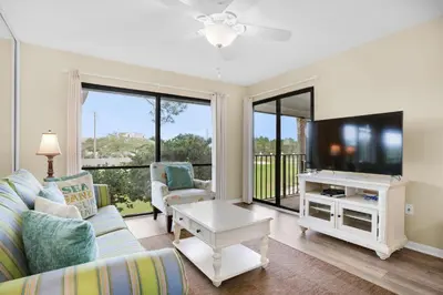 a living room with a couch and a tv at Edgewater Golf Villa 2010 in Panama City Beach