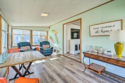 a living room with a table and chairs at Private Bid-A-Wee Beach Access! PCB Home with Pool in Panama City Beach