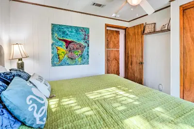 a bedroom with a bed and a painting on the wall at Private Bid-A-Wee Beach Access! PCB Home with Pool in Panama City Beach