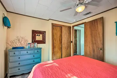 a bedroom with a red bed and a blue dresser at Private Bid-A-Wee Beach Access! PCB Home with Pool in Panama City Beach