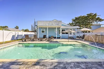 a swimming pool in front of a house at Private Bid-A-Wee Beach Access! PCB Home with Pool in Panama City Beach