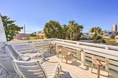 a group of chairs and tables on a patio at Private Bid-A-Wee Beach Access! PCB Home with Pool in Panama City Beach