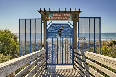 a gate at the beach with a bird on it at Private Bid-A-Wee Beach Access! PCB Home with Pool in Panama City Beach