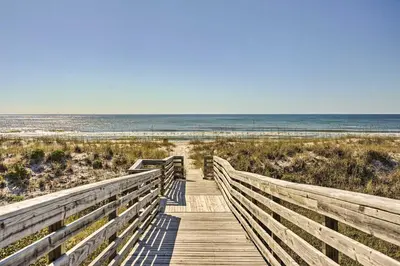 a wooden boardwalk leading to the beach at Private Bid-A-Wee Beach Access! PCB Home with Pool in Panama City Beach