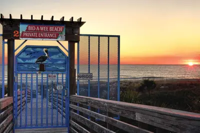 a gate at the beach with a pelican on it at Private Bid-A-Wee Beach Access! PCB Home with Pool in Panama City Beach