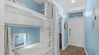 a hallway with blue walls and a white door at Palms C14 in Santa Rosa Beach