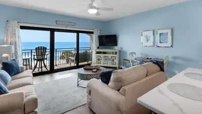 a living room with a couch and a view of the ocean at Palms C14 in Santa Rosa Beach
