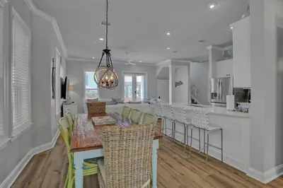 a kitchen and dining room with a table and chairs at The Real McCoy in Panama City Beach