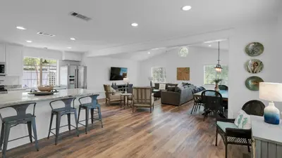 a kitchen and living room with a counter and chairs at 171 Seacrest in Seacrest