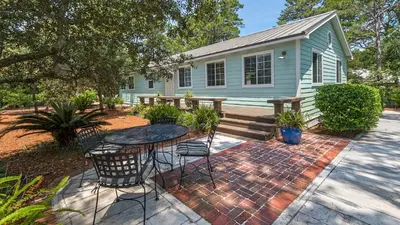 a house with a table and chairs in front of it at 171 Seacrest in Seacrest