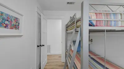 a bedroom with two bunk beds and a ladder at 171 Seacrest in Seacrest