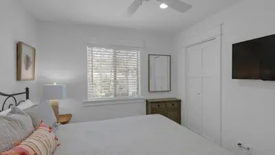 a bedroom with a bed and a flat screen tv at 171 Seacrest in Seacrest