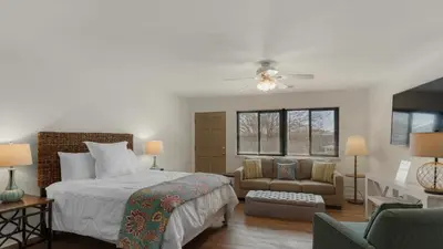 a bedroom with a bed and a couch and a chair at Hidden Beach 219 in Santa Rosa Beach