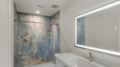 a bathroom with a shower and a sink and a mirror at Hidden Beach 219 in Santa Rosa Beach