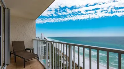 a balcony with a chair and a view of the ocean at Beachcrest 1204 in Santa Rosa Beach