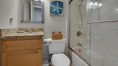 a bathroom with a toilet and a shower and a sink at Beachcrest 1204 in Santa Rosa Beach