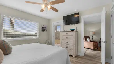 a bedroom with a bed and a ceiling fan at Beacons 1 in Santa Rosa Beach