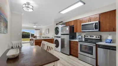 a kitchen with stainless steel appliances and wooden cabinets at Beacons 1 in Santa Rosa Beach