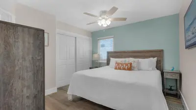 a bedroom with a white bed and a ceiling fan at Beacons 1 in Santa Rosa Beach