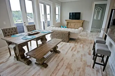 a living room with a wooden table and chairs at Beach Abode in Watersound Beach