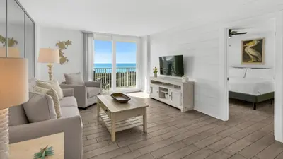 a living room with a couch and a bed and a television at Beachcrest 204 in Santa Rosa Beach