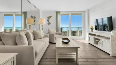 a living room with a couch and a tv at Beachcrest 204 in Santa Rosa Beach