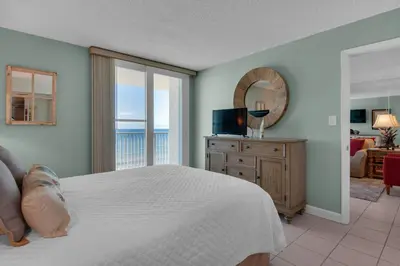 a bedroom with a bed and a view of the ocean at Beachcrest 703 in Santa Rosa Beach
