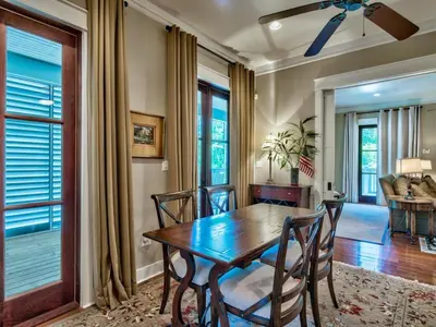 a dining room with a wooden table and chairs at Southern Grounds in Santa Rosa Beach