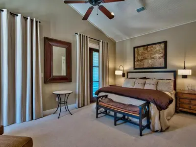 a bedroom with a bed and a ceiling fan at Southern Grounds in Santa Rosa Beach