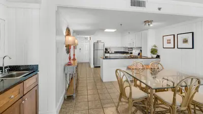 a kitchen with a table and chairs and a counter at Beachcrest 304 in Santa Rosa Beach