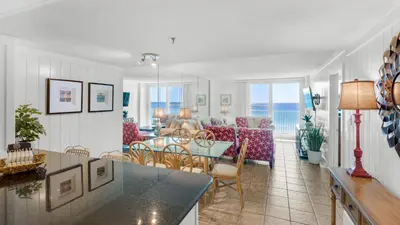 a dining room and living room with a view of the ocean at Beachcrest 304 in Santa Rosa Beach