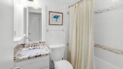 a white bathroom with a sink and a toilet at Beachcrest 304 in Santa Rosa Beach