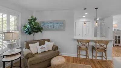 a living room with a couch and a table at La Pointe in Santa Rosa Beach
