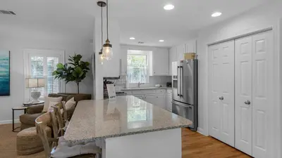 a kitchen with a counter top and a refrigerator at La Pointe in Santa Rosa Beach