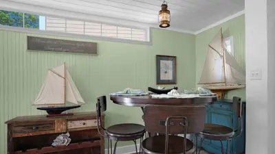 a room with a bar with a model boat on the wall at Sea Turtle Pass in Santa Rosa Beach