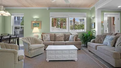 a living room with two couches and a table at Sea Turtle Pass in Santa Rosa Beach