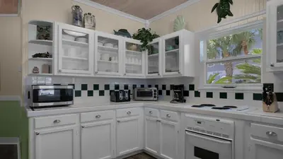 a white kitchen with white cabinets and appliances at Sea Turtle Pass in Santa Rosa Beach