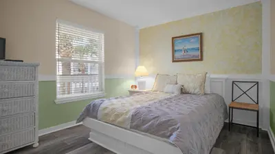 a bedroom with a bed and a window at Sea Turtle Pass in Santa Rosa Beach