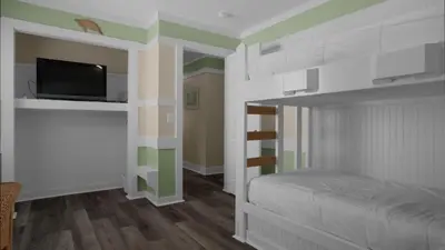 a bedroom with a bunk bed with a flat screen tv at Sea Turtle Pass in Santa Rosa Beach