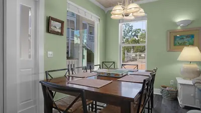 a dining room with a wooden table and chairs at Sea Turtle Pass in Santa Rosa Beach