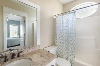 a bathroom with a sink and a toilet and a mirror at Villas At Sunset Beach A302 - Sunset Villa in Rosemary Beach