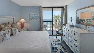 a bedroom with a bed and a view of the ocean at Beachcrest 403 in Santa Rosa Beach