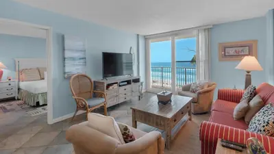 a living room with a television and a bedroom with a bed at Beachcrest 403 in Santa Rosa Beach