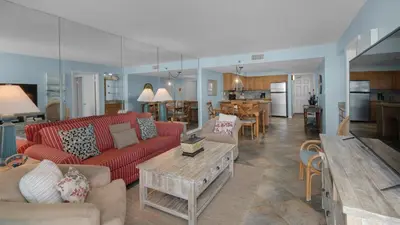 a living room with a red couch and a table at Beachcrest 403 in Santa Rosa Beach