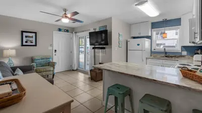 a kitchen and living room with a couch and a counter at Beachside Villas 513 in Santa Rosa Beach
